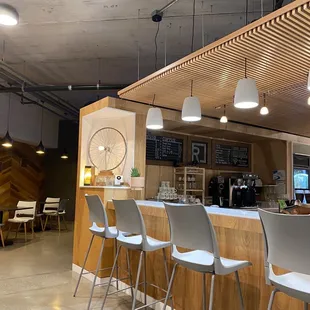 a bar with stools and tables
