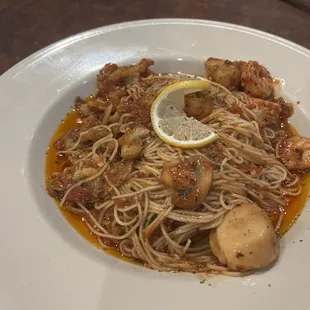 Seafood trio over angel hair pasta
