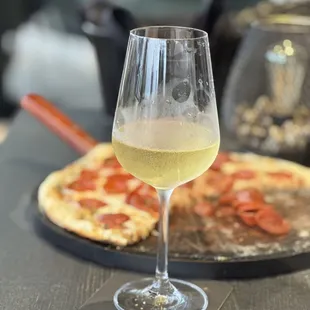 a glass of wine and a pizza