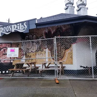 Boarded up but still open.