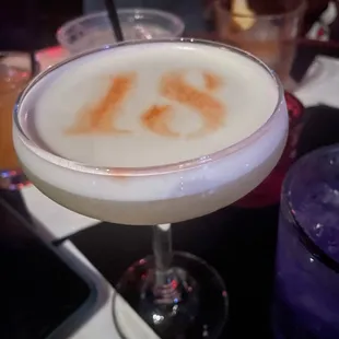 a close up of a drink in a coupe glass