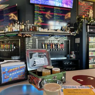 Espresso martini and flight of beer inside a vintage tin lunchbox