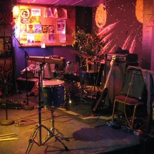 a drum set up in a dimly lit room