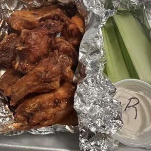 Chicken Wings Buffalo flavored with a side of celery