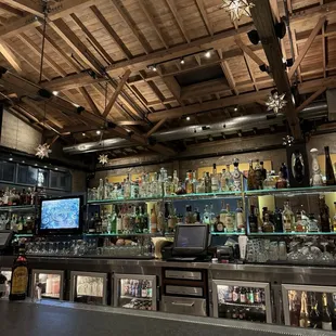 a bar with many bottles of alcohol