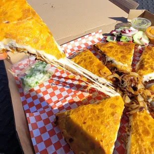 a hand holding a slice of pizza