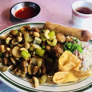 a plate of chinese food and a cup of tea