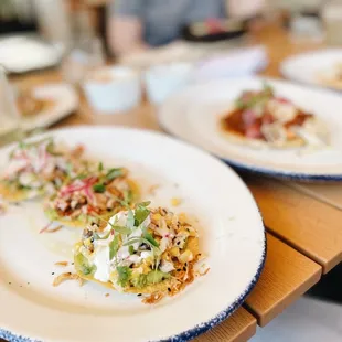 two plates of food on a wooden table