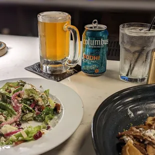 a plate of salad and a beer