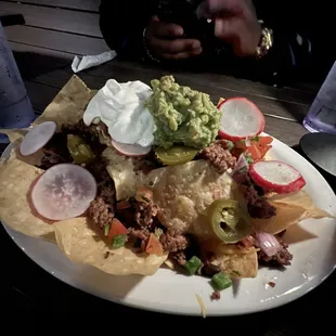 Nachos are delicious! 1st time seeing radish atop but it mixes well!