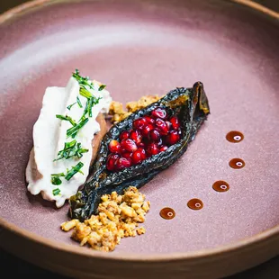 Chocolate mousse, chile ancho, walnut sauce, or as the Spanish know it, "nogada". pomegranate, and tarragon.