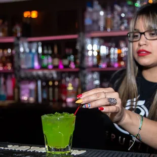 a woman pouring a drink
