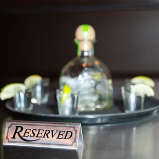 a bottle of alcohol and shot glasses