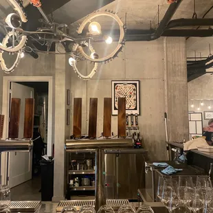 a bar with wine glasses on the counter