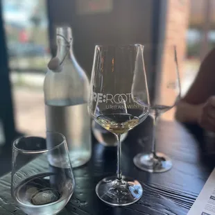 a wine glass and a bottle on a table