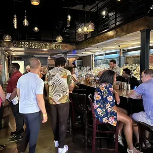 a group of people sitting at a bar