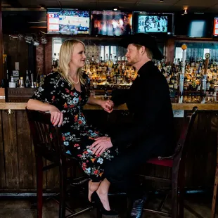 a man and a woman sitting at a bar