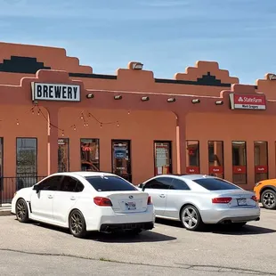 two cars parked in front of a building