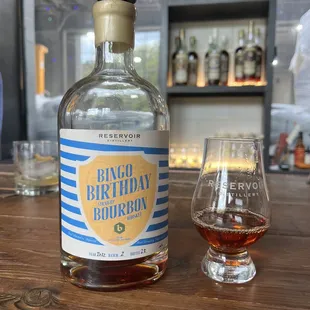 a bottle of bourbon next to a glass
