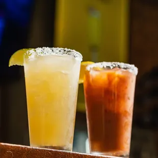 two cocktails on a wooden table