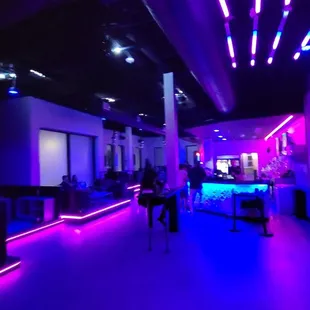 a brightly lit room with purple and blue lighting