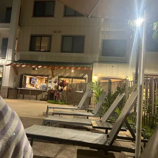 lounge chairs and umbrella at night