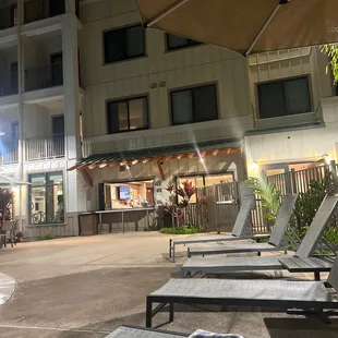 lounge chairs and umbrella at night