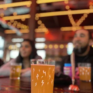 a glass of beer on a bar