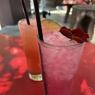 two cocktails on a red table
