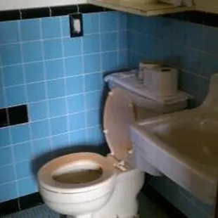 note the broken tile where a single towel-bar used to be