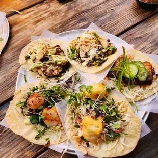 Starting from bottom and going counterclockwise: Daily Fish, Pork Belly Burnt Ends, Brussels Sprouts, Caramelized Cauliflower, Diver Scallop