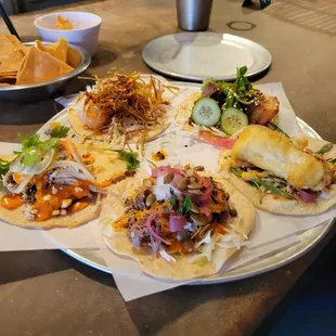 The Tacos, from the top clockwise: Shrimp Tempura, Pork Burnt Ends, Fish, Lamb Barbacoa, Pecan Smoked Chicken.