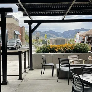 a patio with tables and chairs