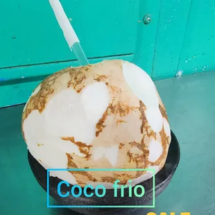 a coconut drink with a straw
