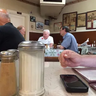 a man sitting at a table in a restaurant