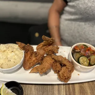 Chicken wings, mashed potatoes, and Seasonal Vegetables