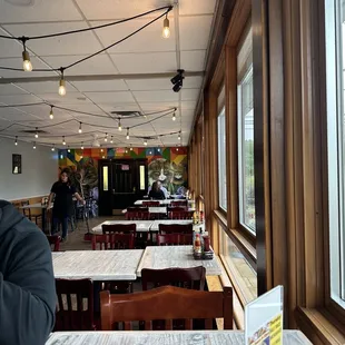 a man sitting at a table looking out a window