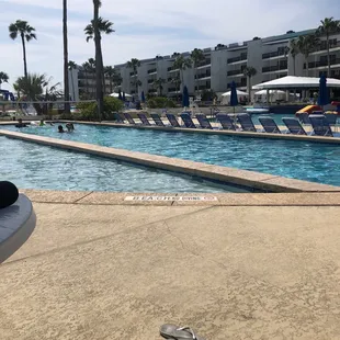 a pair of flip flops by the pool