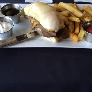 a steak sandwich and fries