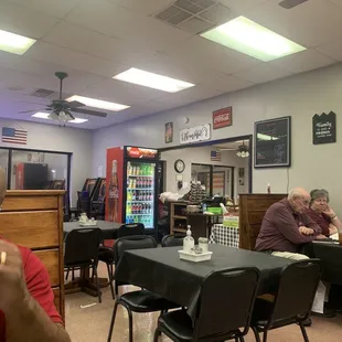 Dining area.  Sticky table cloths. Probably never changed.