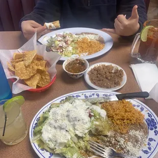 enchiladas and flauta plates with some drinks on the side, so delicious! the portions are huge