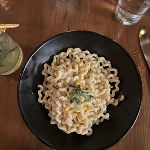 a plate of pasta with corn