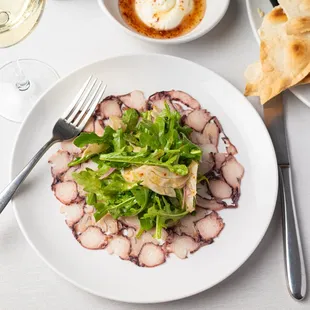 a plate of food and a glass of wine