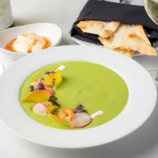 a bowl of soup and a glass of wine