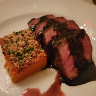 a plate of food with meat and sauce