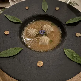 a plate of dumplings and a glass of wine