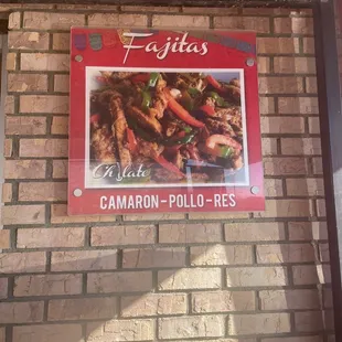 a sign on a brick wall
