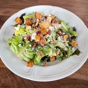 House salad with crumbled blue cheese, homemade French dressing, and bacon
