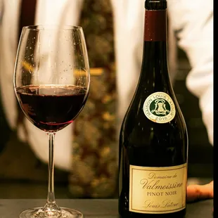 a glass of wine and a bottle of wine