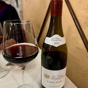 a glass of wine and a bottle of wine